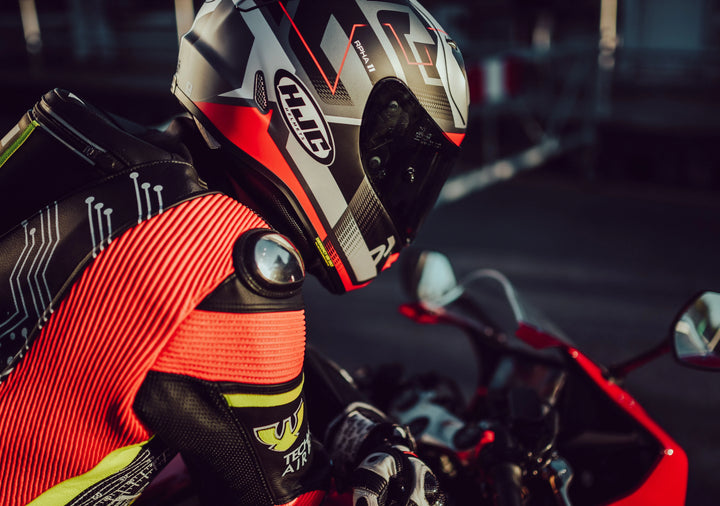 HJC motorcycle helmet on a leather suited motorcyclist sitting on a sportsbike.